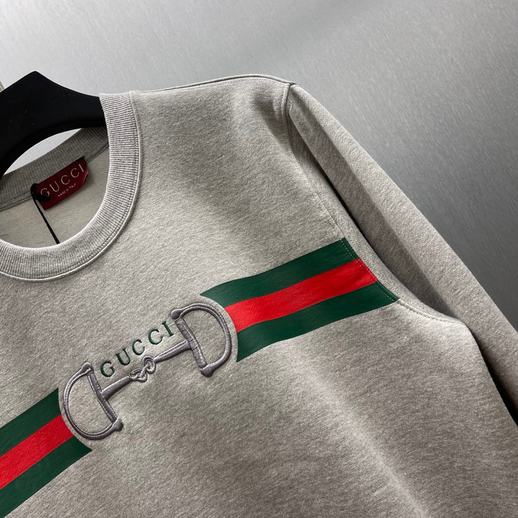 Light gray Gucci sweatshirt showing striped logo and embroidered double-G detail