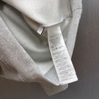 Light gray Gucci sweatshirt care label tag visible inside neckline