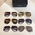Versace sunglasses display with mixed frames and tinted lenses in rows