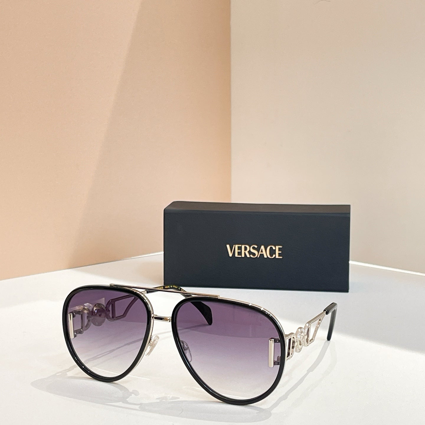 Versace sunglasses with black frames and amber-tinted lenses