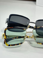 Close-up square sunglasses with gold-tone accents and dark lenses