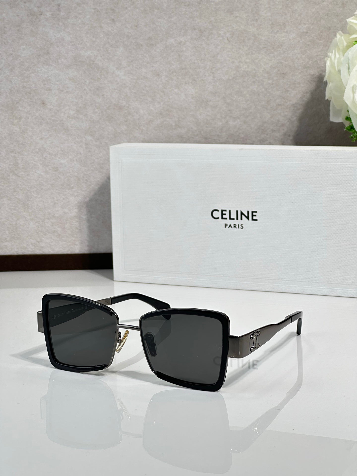 Square sunglasses with black frame and dark lenses