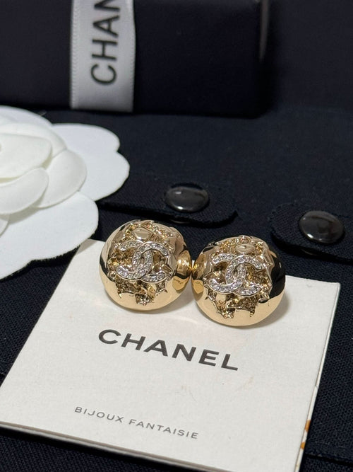 Gold-tone round stud earrings with sparkling crystal halo and logo-style motif