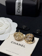 Gold-tone round stud earrings with crystal halo, one showing the earring post