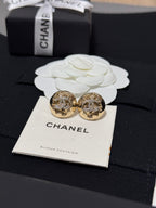 Gold-tone round stud earrings with crystal halo motif on a jewelry card