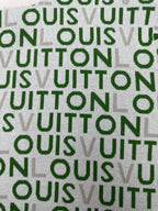 Green-and-white patterned fabric with repeating text-style logo