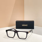 Versace eyeglasses with black rectangular frames, clear lenses, and gold accents.