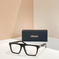 Versace eyeglasses with black rectangular frames and gold logo details.