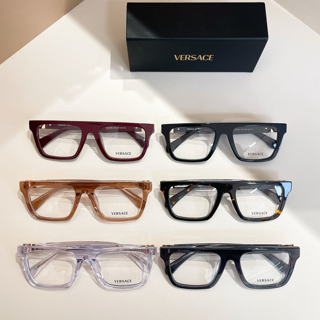 Assorted Versace eyeglasses on display, red, amber, and blue-black frames with clear lenses.