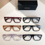 Assorted Versace eyeglasses on display, red, amber, and blue-black frames with clear lenses.