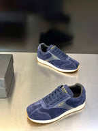 Prada unisex suede sneakers in blue, side view pair with lace-up uppers and cream soles.