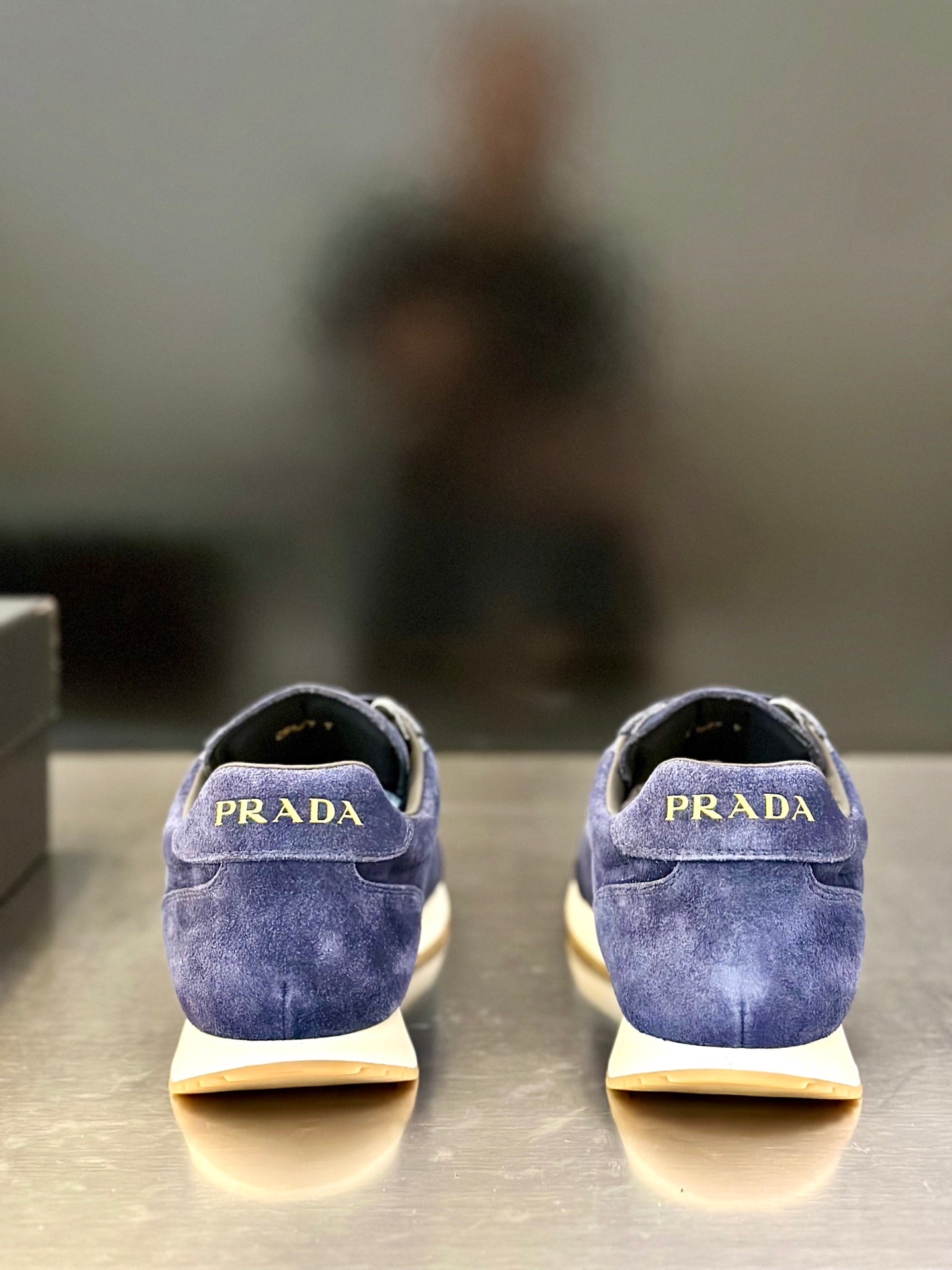 Prada unisex suede sneakers, blue backs with “PRADA” logo on the heel tabs.