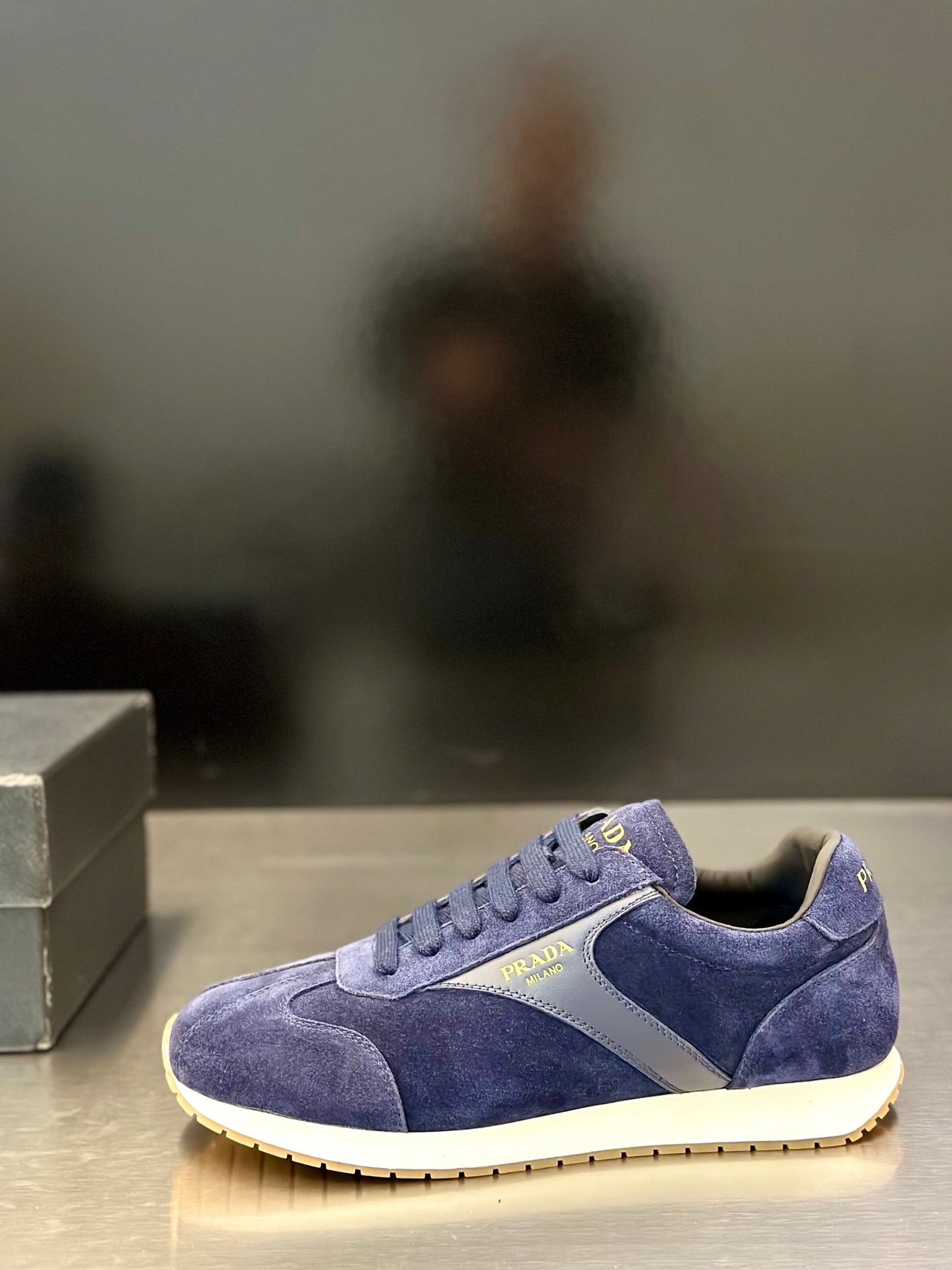 Prada unisex suede sneakers, blue, angled side view with lace-up and contrast panel detail.