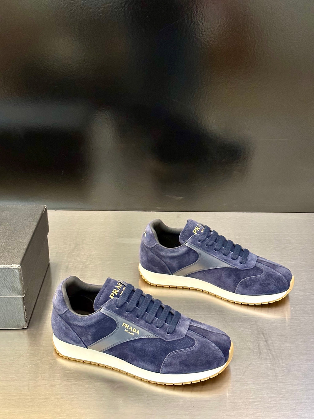 Prada unisex suede sneakers, blue with lace-up fronts and white/gold rubber soles.