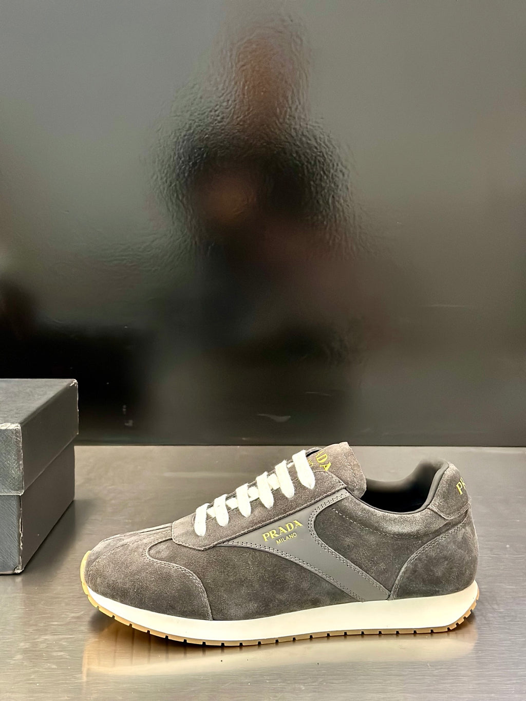 Prada unisex lace-up sneakers, dark gray suede with white laces and side logo patch