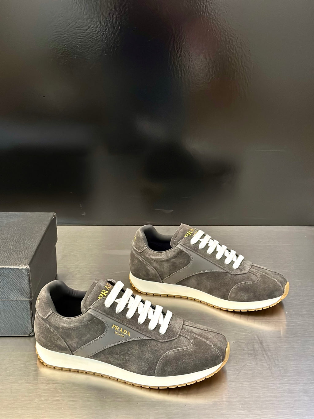 Prada unisex lace-up sneakers, dark gray suede with white laces and rubber sole