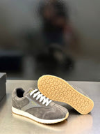 Prada unisex lace-up sneakers, dark gray suede with white laces and textured yellow outsole