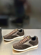 Prada unisex low-top sneakers, dark brown suede with white midsole and lace-up.