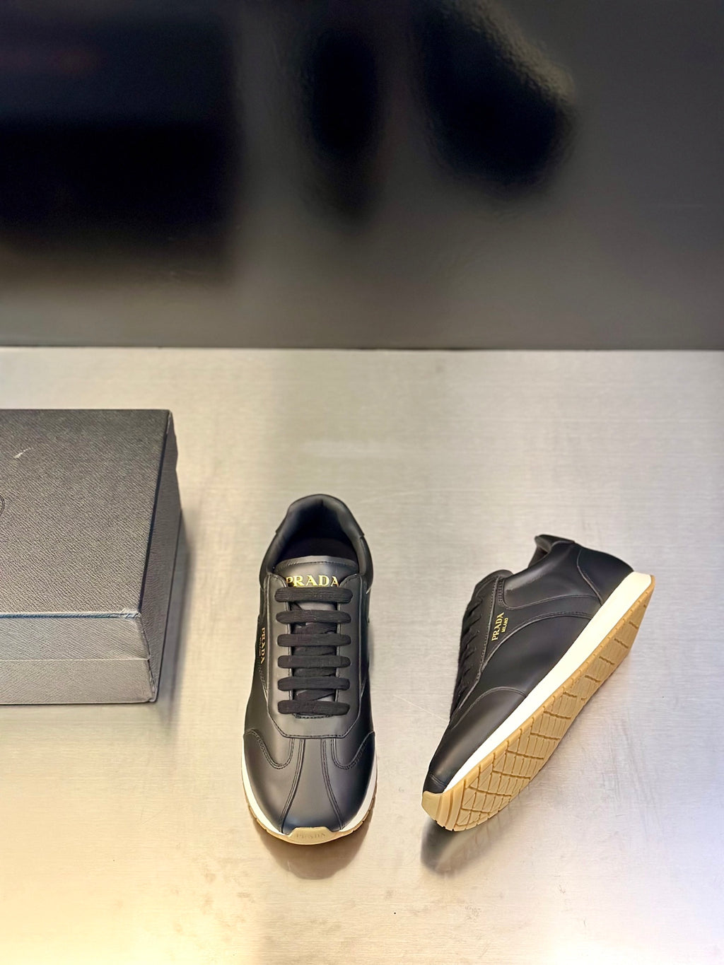 Prada leather lace-up sneaker in dark navy with side logo and light trim sole