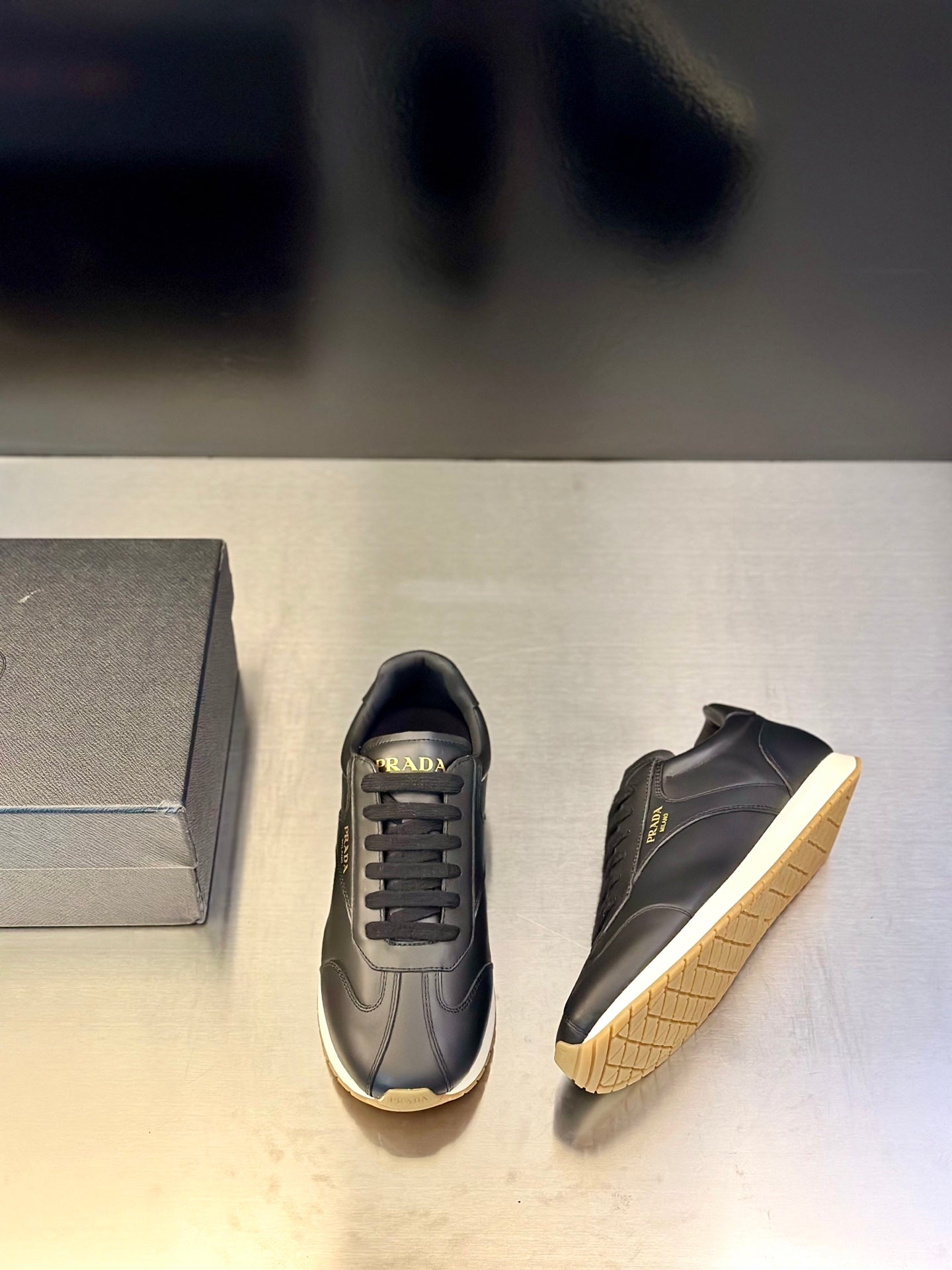 Prada leather lace-up sneaker in dark navy with side logo and light trim sole