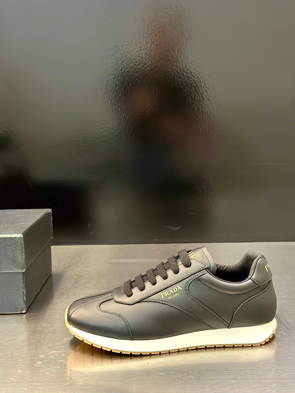 Prada leather lace-up sneaker in light gray with side logo and contrast sole