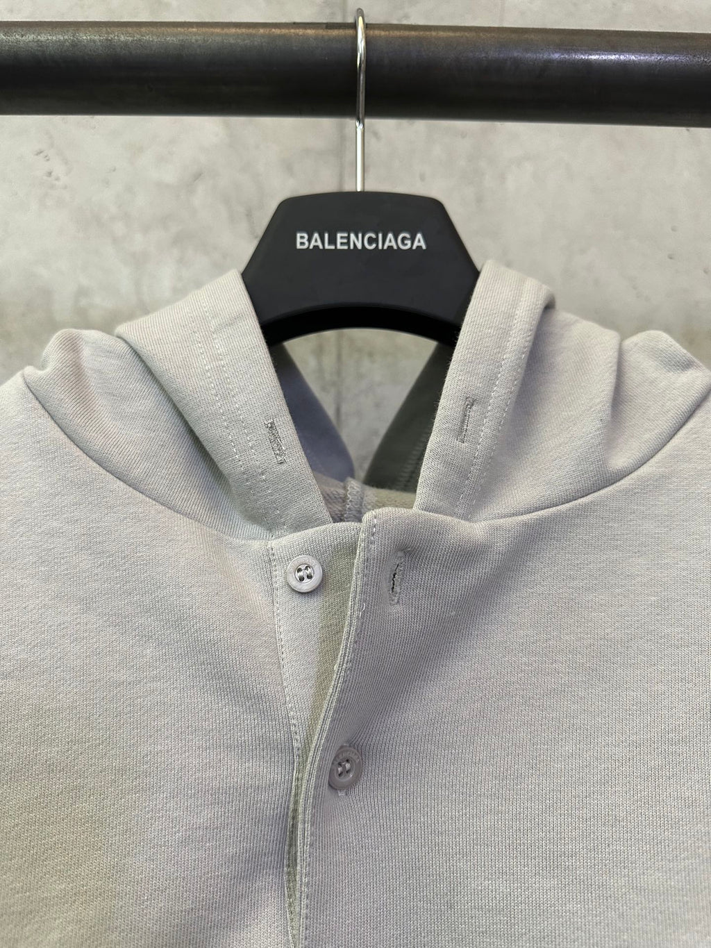 Light gray hooded button placket sweatshirt with small chest buttons