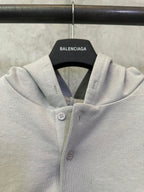 Light gray hooded button placket sweatshirt with small chest buttons