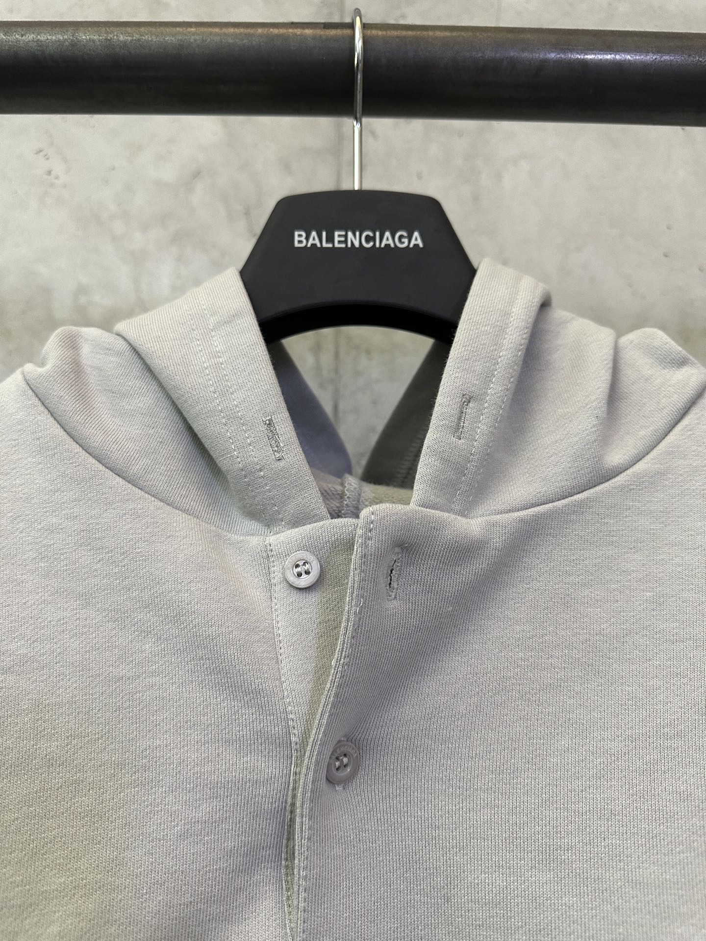 Light gray hooded button placket sweatshirt with small chest buttons