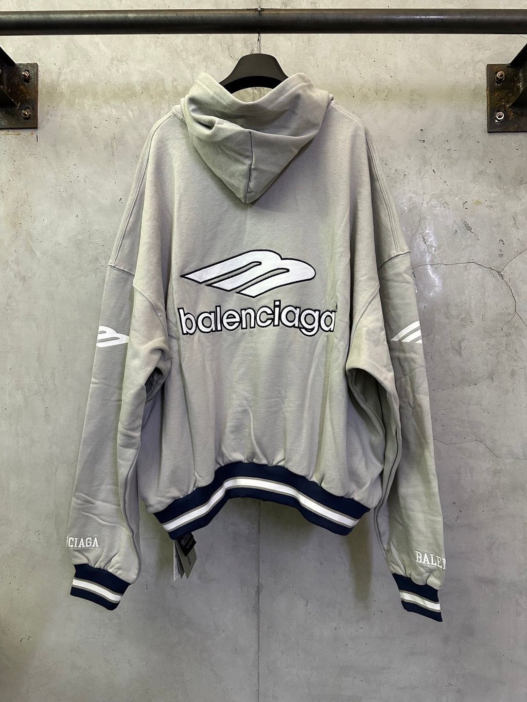 Light gray oversized hoodie with hood, large front Balenciaga logo, striped cuffs