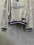 Light gray hoodie with large front Balenciaga graphic, patch detail, and striped cuffs