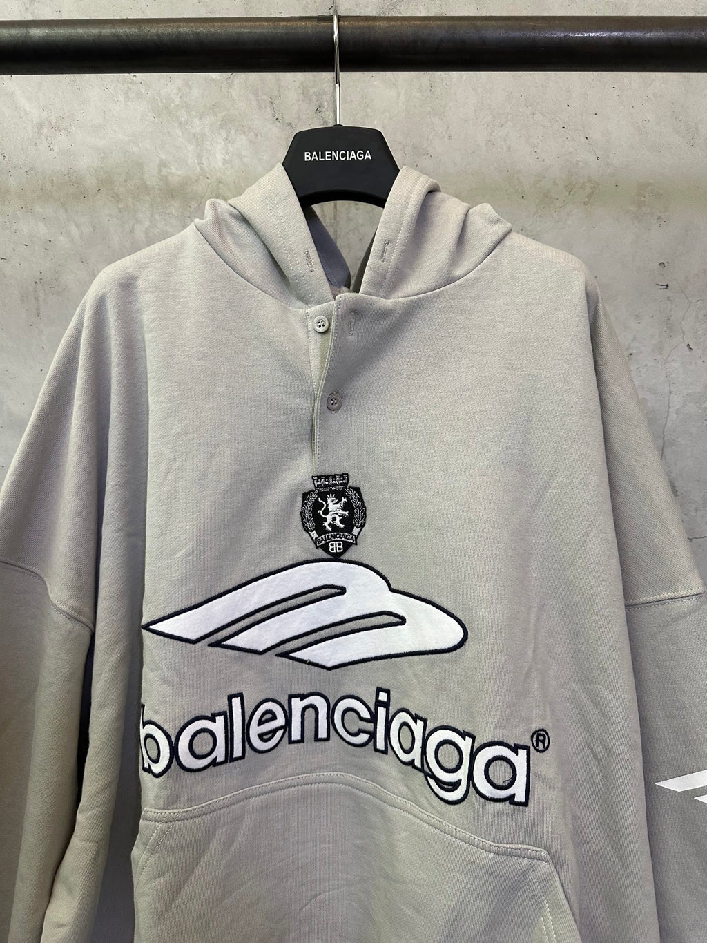 Light gray button-front hoodie with hood, front emblem and large Balenciaga logo