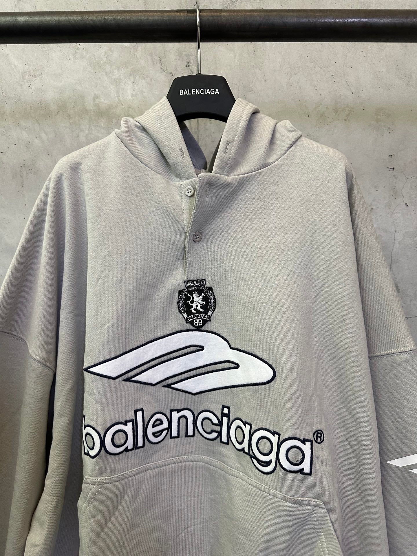 Light gray button-front hoodie with hood, front emblem and large Balenciaga logo