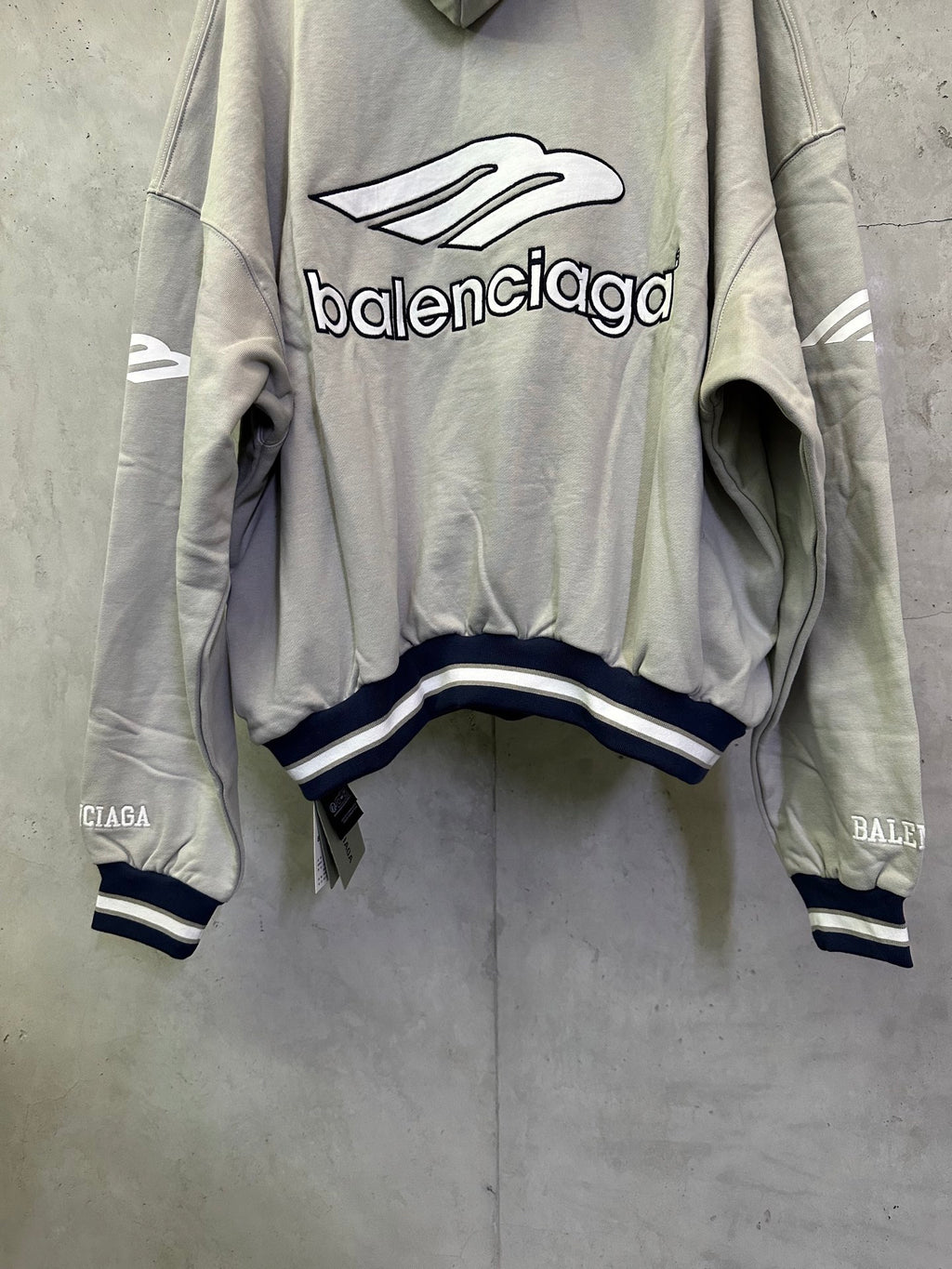 Light gray hoodie with large front Balenciaga graphic and striped waistband cuffs