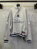 Light gray long-sleeve hoodie with front Balenciaga logo and striped cuffs at hem