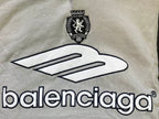Light gray chest area of hoodie with large Balenciaga logo and crest emblem