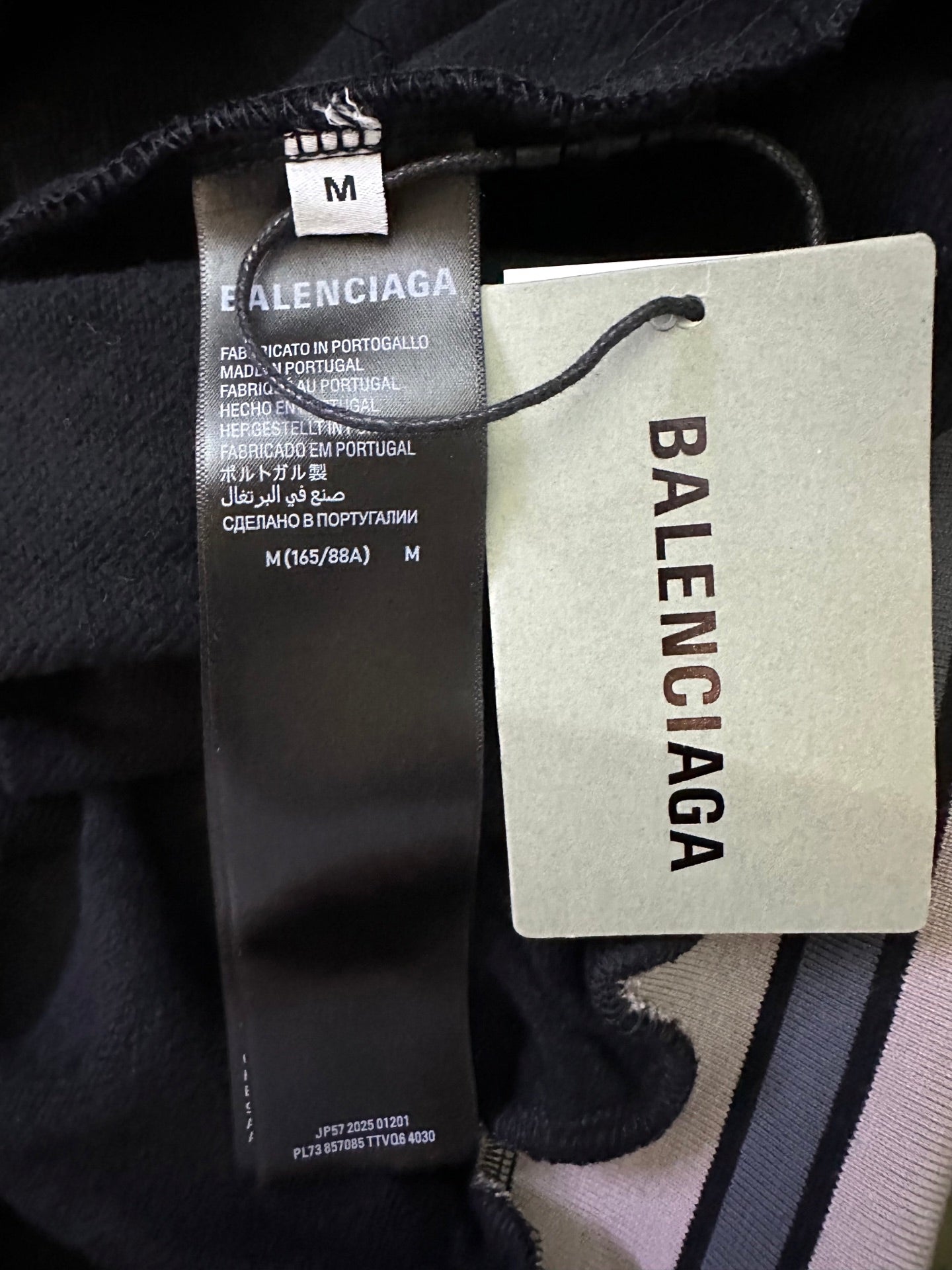 Black Balenciaga hoodie size tag and fabric label inside collar