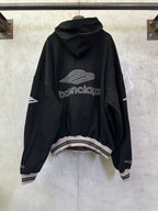 Black Balenciaga hoodie, back view with large logo print and striped hem cuffs