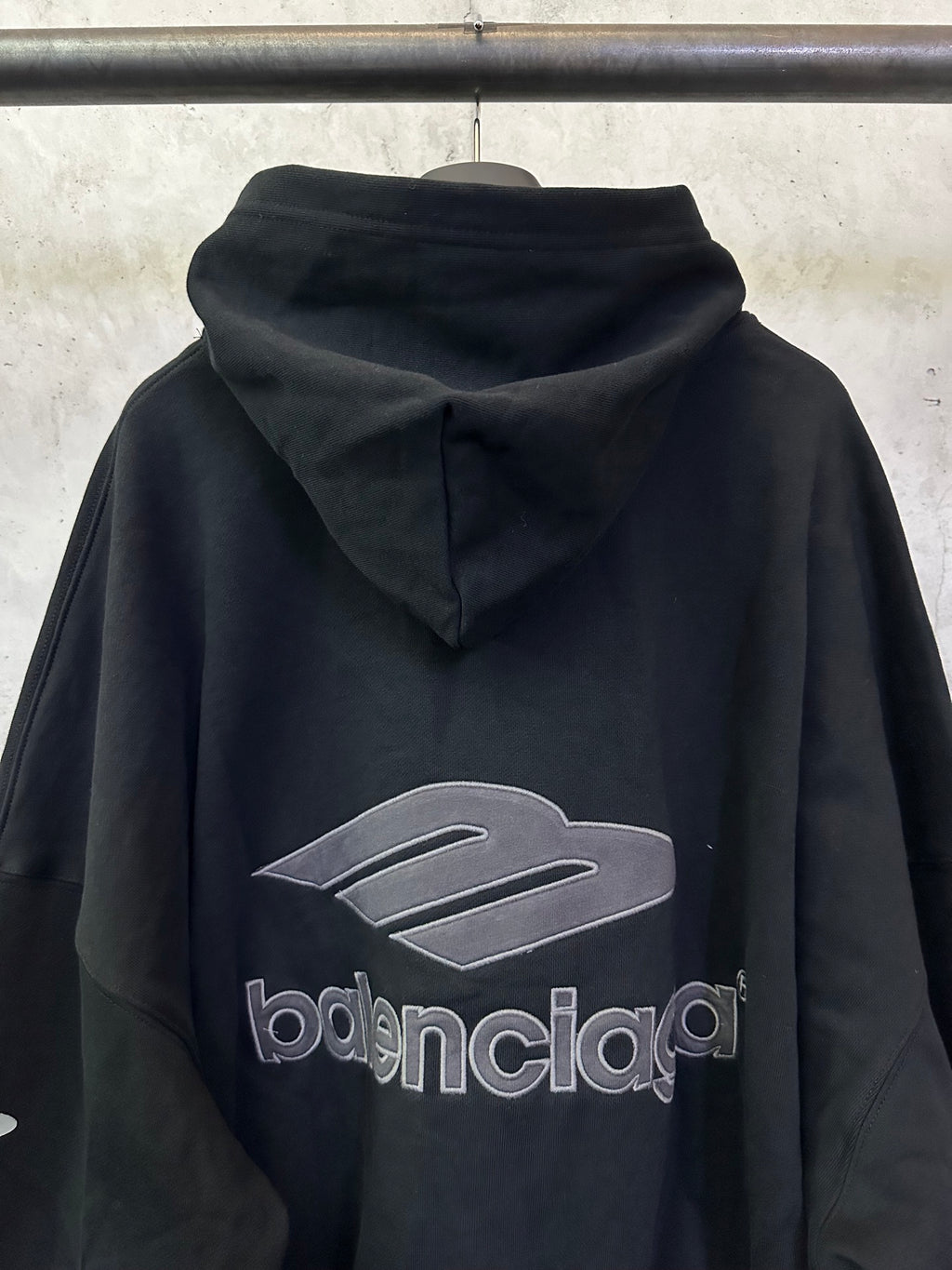 Black Balenciaga hoodie back view with hood and large logo graphic