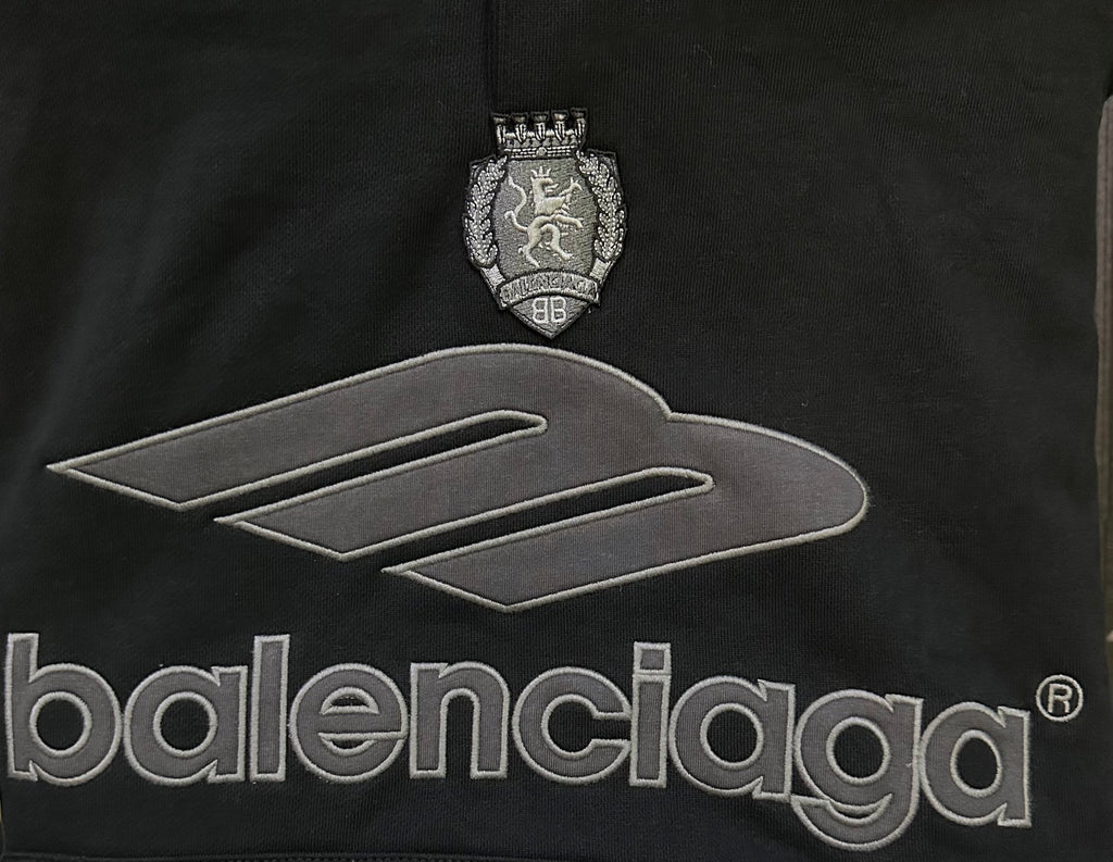 Black Balenciaga hoodie front close-up showing crest and large logo text