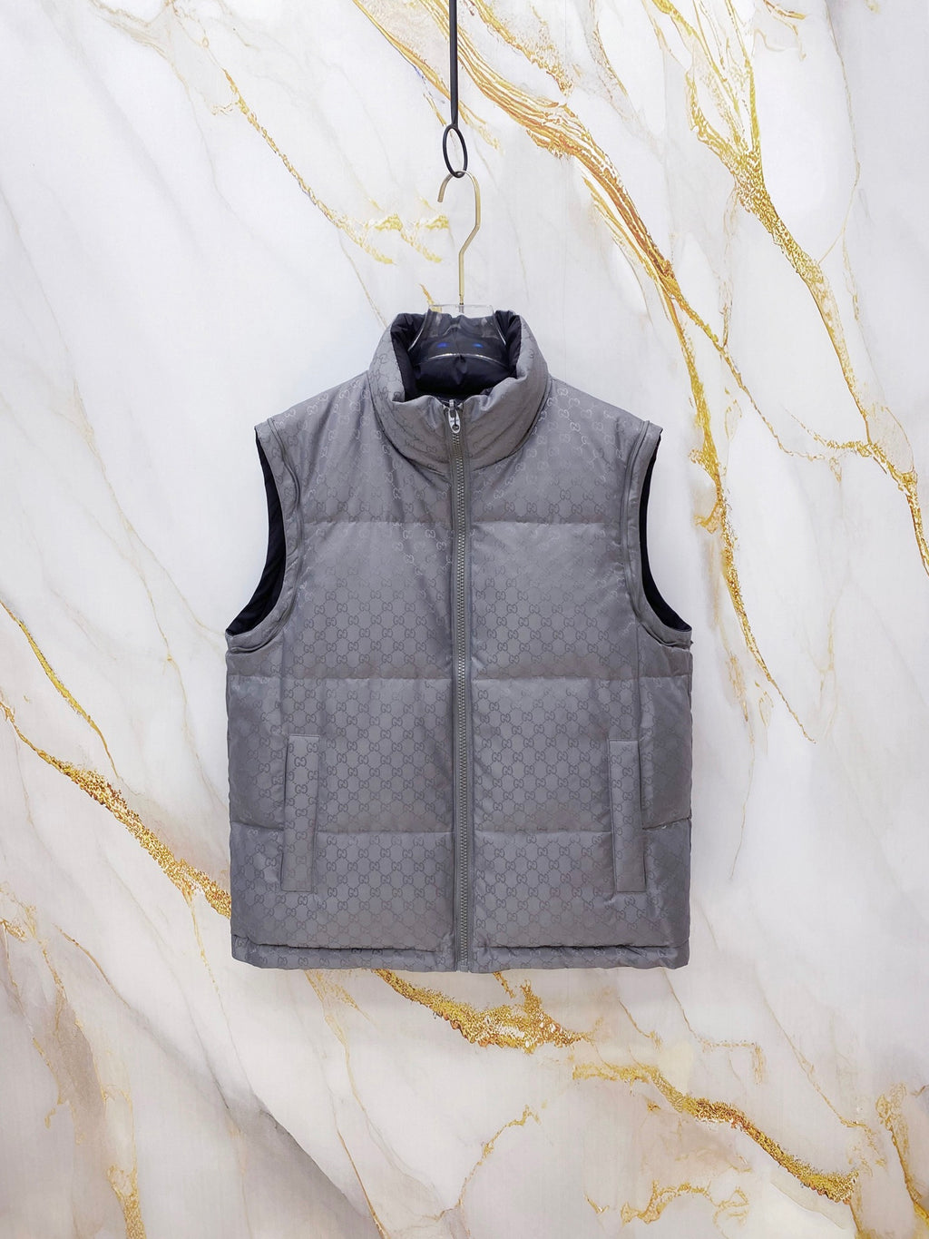 Dark gray Gucci puffer vest with quilted panels and front zipper