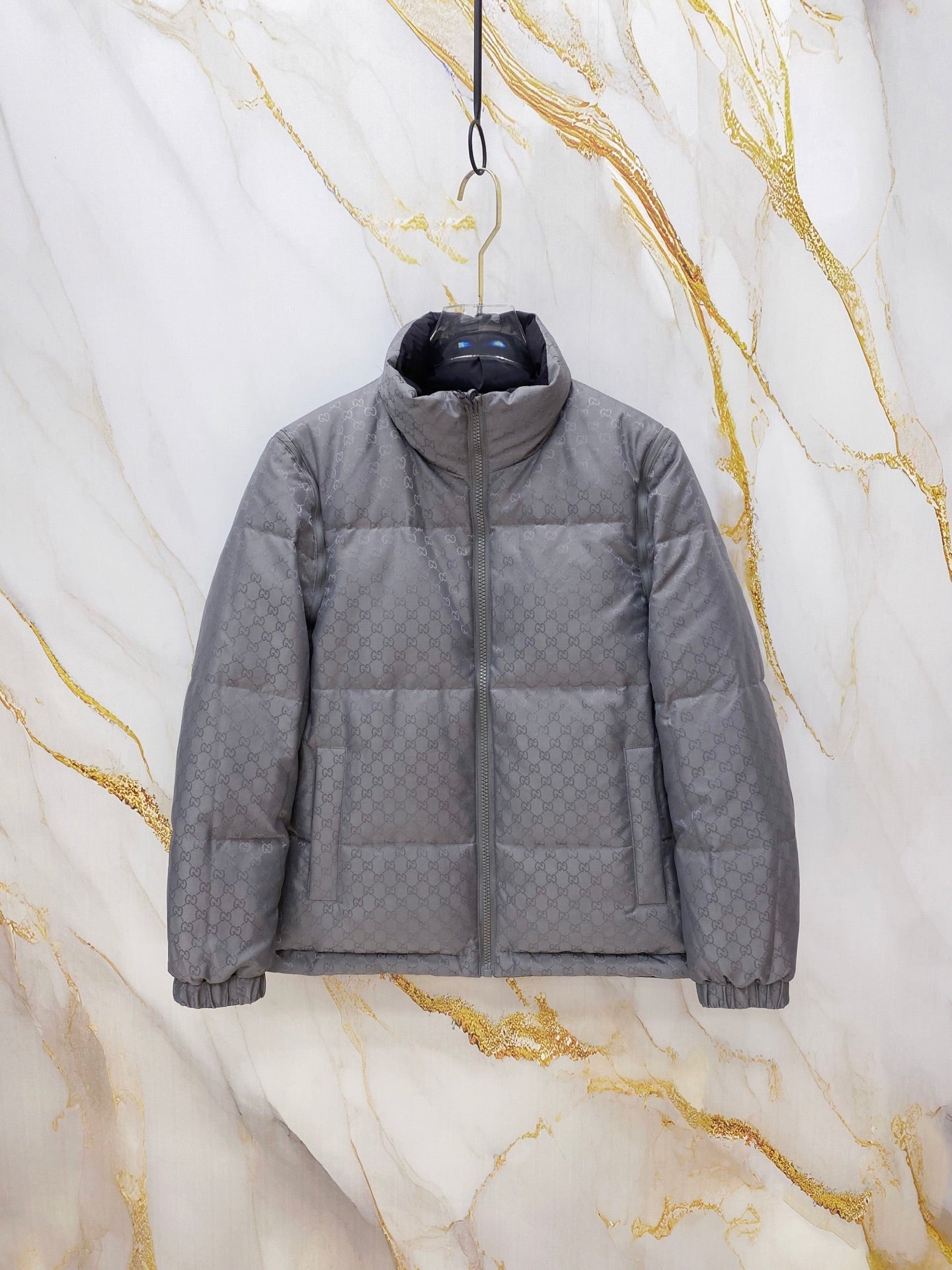 Gucci long puffer jacket in dark gray, hooded with full front zipper and quilted panels.