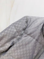 Gucci long puffer jacket shoulder and sleeve in dark gray with GG monogram pattern.