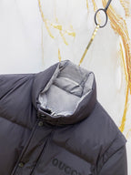 Dark gray puffer vest with hood pocket, buttons, and Gucci chest logo