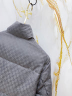 Gucci long puffer jacket sleeve in dark gray with allover GG pattern, quilted texture.