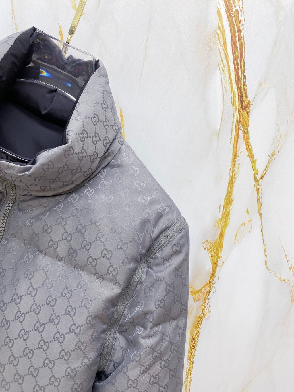 Gucci long puffer jacket torso in dark gray, allover GG pattern and front zip.