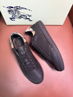 Dark leather lace-up sneakers with black laces, one shoe side view