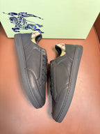 Dark leather lace-up sneakers with black laces, side and toe views
