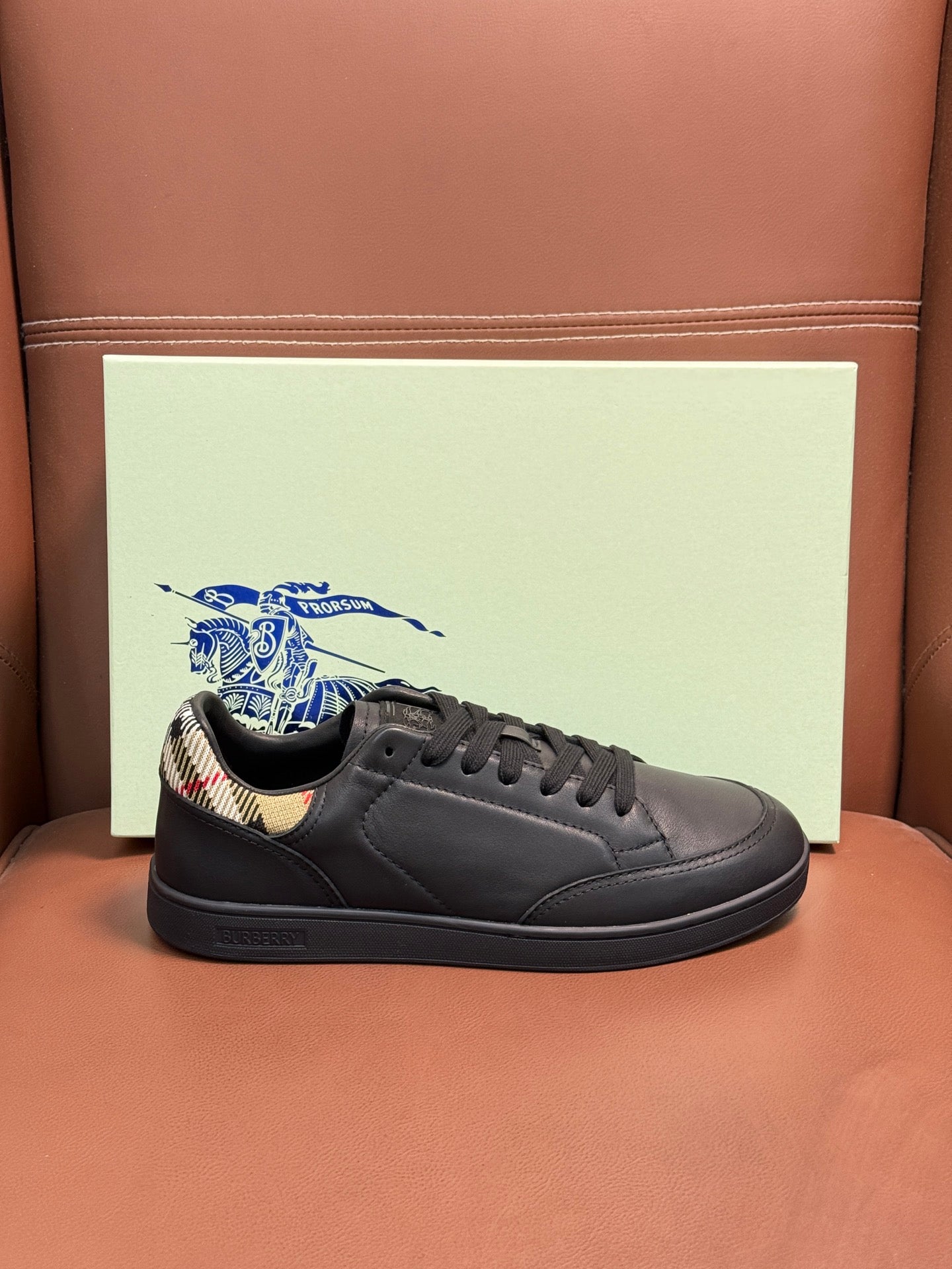Dark leather lace-up sneaker with black laces and patterned collar lining