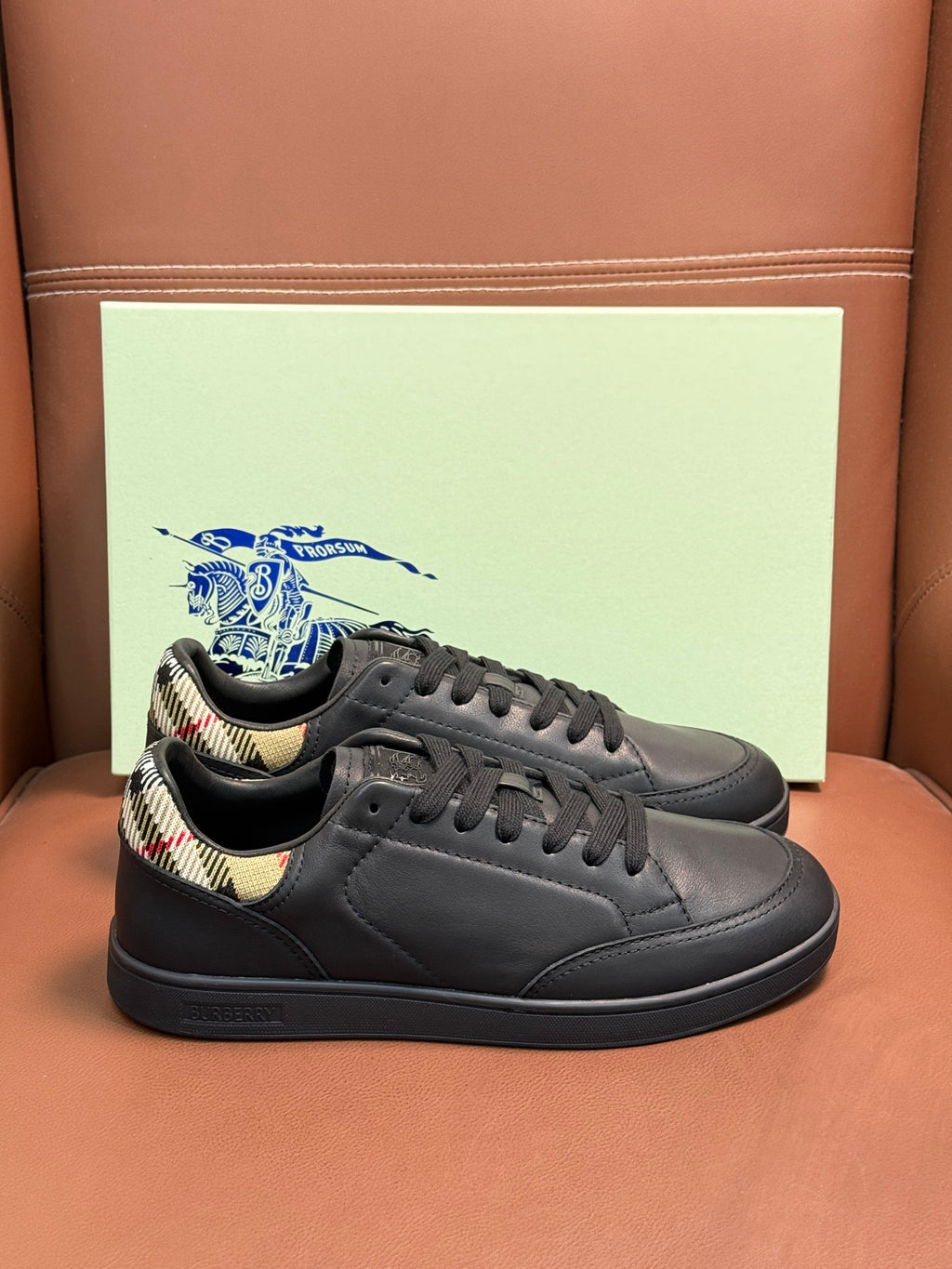 Dark leather lace-up sneaker with black laces and patterned collar lining