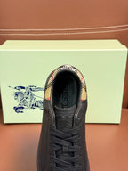 Dark leather sneaker with black laces and patterned interior collar
